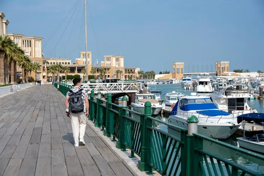 Young man walking on Souq Sharq promenade in Kuwait City, Middle East. Image used for illustrative purpose. Getty Images , Getty Images
