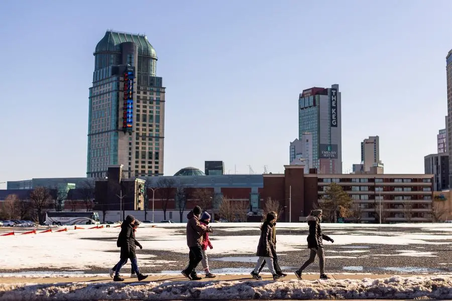 FILE PHOTO: A group of people walk along a road, in Niagara Falls, Ontario, Canada March 7, 2023. REUTERS/Carlos Osorio. , Reuters