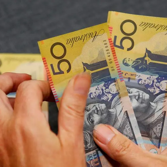 Dollar holds gains ahead of inflation data; Aussie awaits RBA