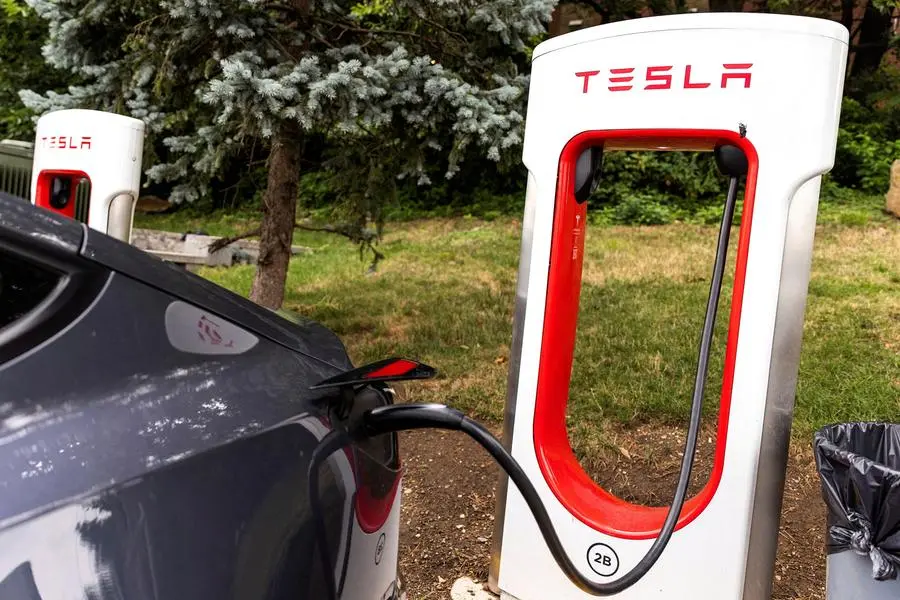 FILE PHOTO: A Tesla electric vehicle uses a supercharging station in Union City, New Jersey, U.S., July 23, 2024. REUTERS/Eduardo Munoz. , Reuters