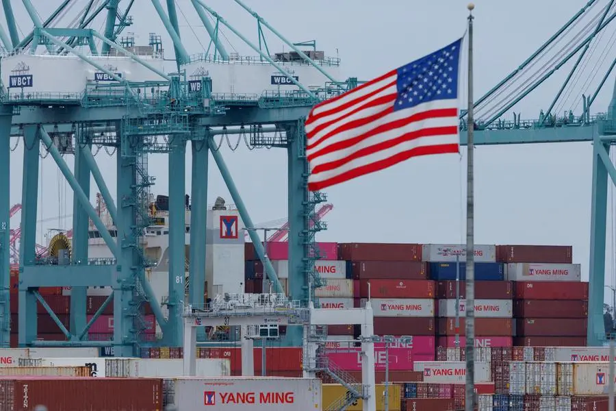 FILE PHOTO: A U.S. flag flutters near shipping containers as a ship is unloaded at the Port of Los Angeles, in San Pedro, California, U.S., May 1, 2025. REUTERS/Mike Blake. , Reuters