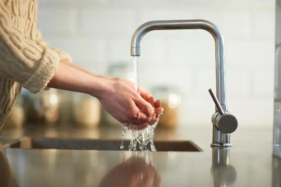 A woman washes her hands in the kitchen sink, close up. Image used for illustrative purpose. Getty Images , Getty Images