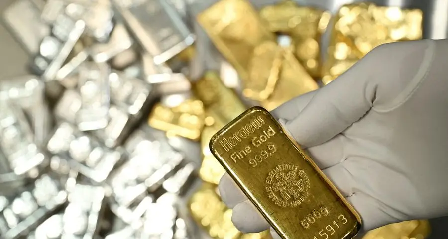 Gold edges higher on US rate outlook; silver dips but stays near record high