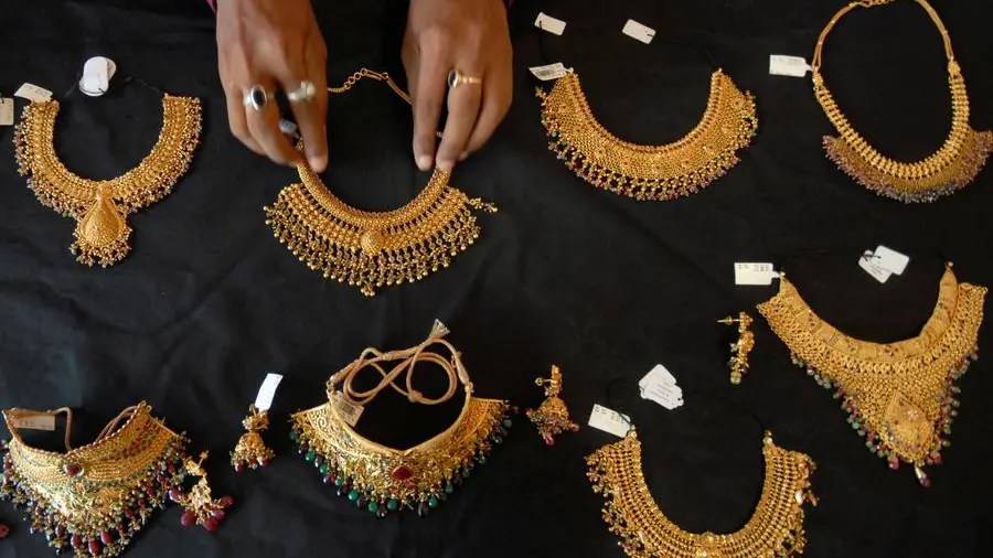 Gold rises on dip-buying but heads for fourth weekly loss