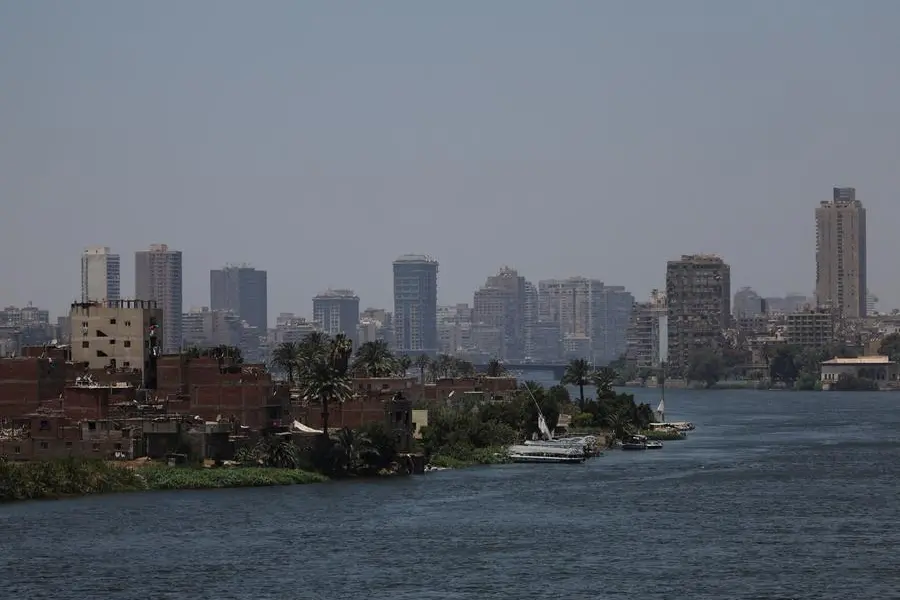 A general view of a farmland with houses on small island next to crowded residential buildings and bridges on the bank of River Nile, as continuous population growth and urban sprawl erode the banks of the River Nile, in Cairo, Egypt, May 22, 2025. REUTERS/Amr Abdallah Dalsh. , Reuters