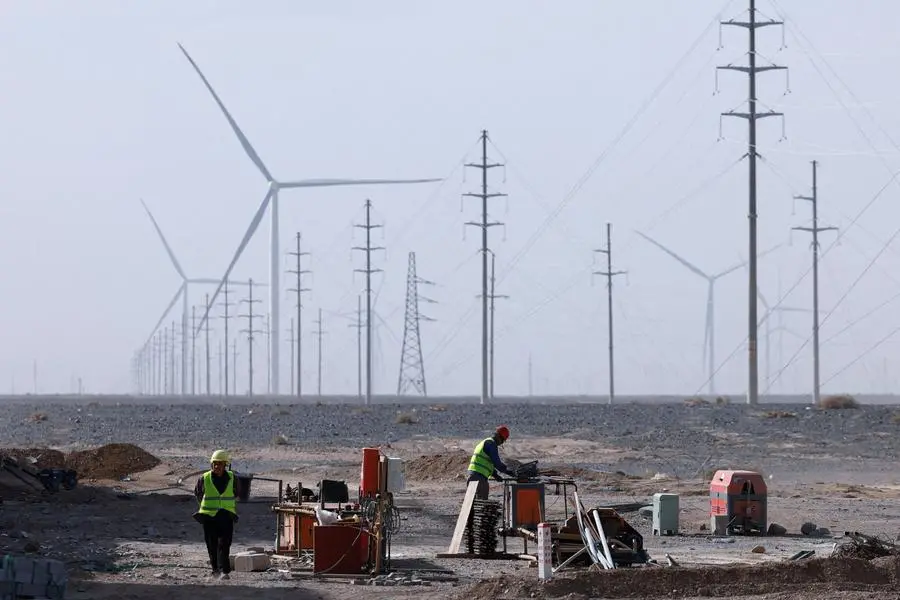 FILE PHOTO: Workers at a construction site at a Taiyuan New Energy Co wind farm, during an organised media tour in Jiuquan, Gansu province, China October 17, 2024. REUTERS/Tingshu Wang. , Reuters