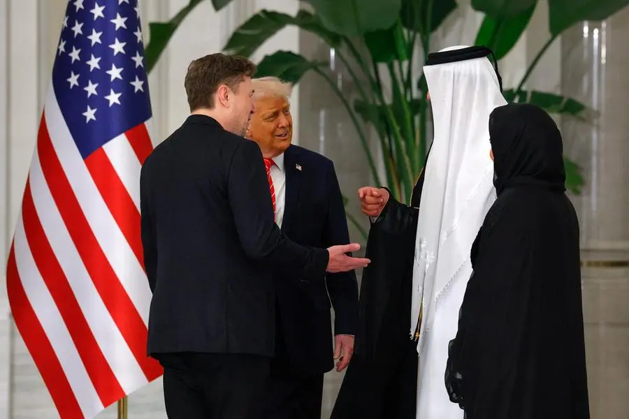 U.S. President Donald Trump speaks with Tesla CEO Elon Musk and Qatar\\'s Emir Tamim bin Hamad Al Thani ahead of a state dinner at Lusail Palace in Lusail, Qatar, May 14, 2025. REUTERS/Brian Snyder. , Reuters