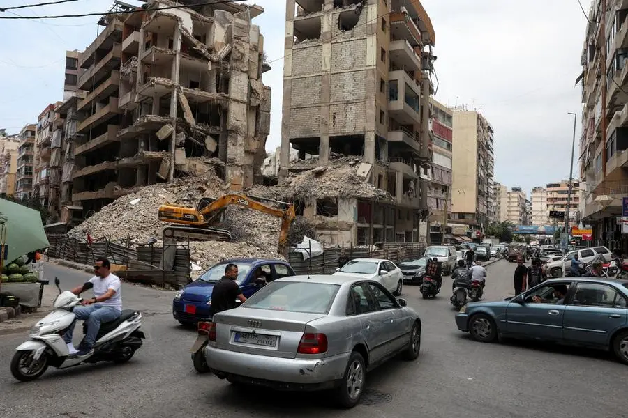 Cars and motorbikes drive near damaged buildings in Beirut southern suburbs, Lebanon June 23, 2025. REUTERS/Mohamed Azakir. , Reuters