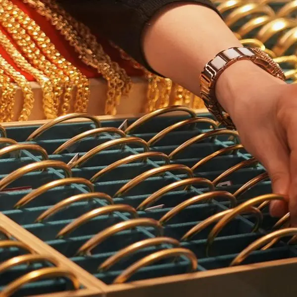 Gold falls on firmer dollar, rising rate-hike expectations