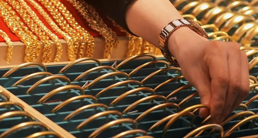 Gold falls on firmer dollar, rising rate-hike expectations