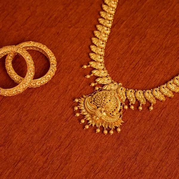 Gold climbs on soft employment data, lower oil ahead of US payrolls report