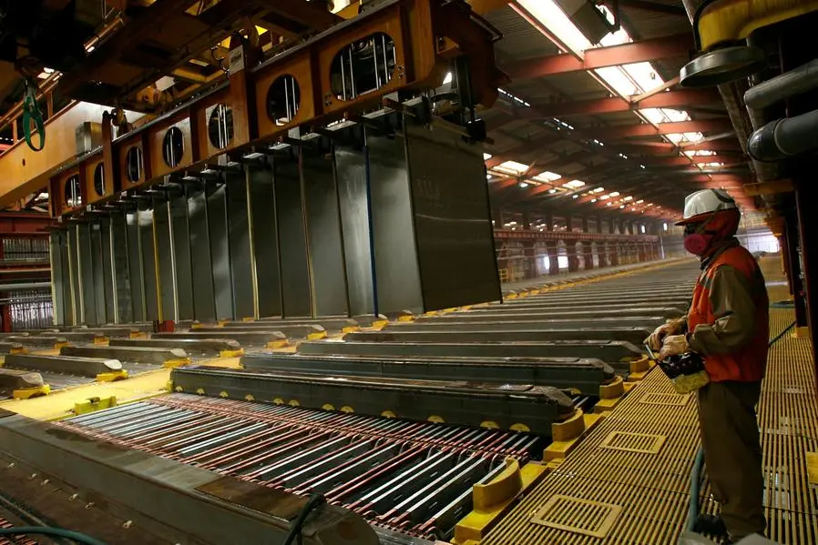 FILE PHOTO: A worker from BHP\\'s Escondida, the world\\'s biggest copper mine, is pictured inside a copper cathodes plant in Antofagasta, Chile March 31, 2008. Picture taken March 31, 2008. REUTERS/Ivan Alvarado. , Reuters