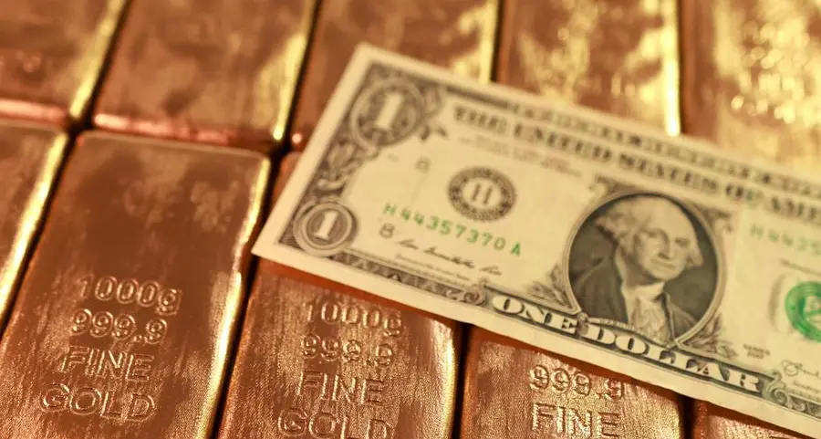 Gold gains on weaker dollar, easing inflation concerns