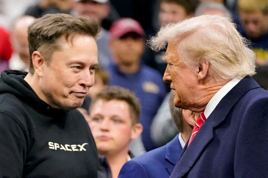 FILE PHOTO: Elon Musk greets U.S. President Donald Trump as they attend the NCAA men\\'s wrestling championships in Philadelphia, Pennsylvania, U.S., March 22, 2025. REUTERS/Nathan Howard/File Photo , Reuters/REUTERS