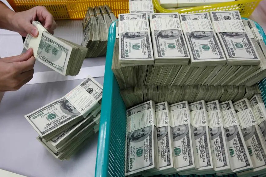 FILE PHOTO: A bank employee counts U.S. hundred dollar bills at Kasikornbank in Bangkok in this January 21, 2010 file photo. REUTERS/Sukree Sukplang. , Reuters