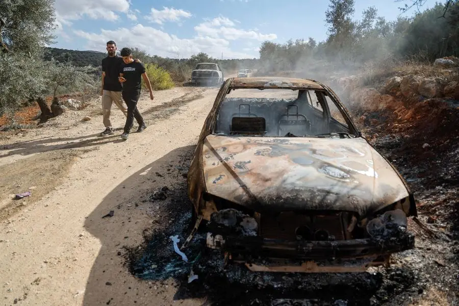 West Bank farmers gather precious olives as harvest season brings new settler attacks