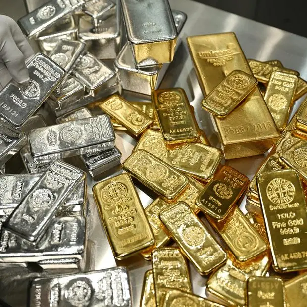 Gold edges lower after a divided Fed cuts rates; silver hits record high