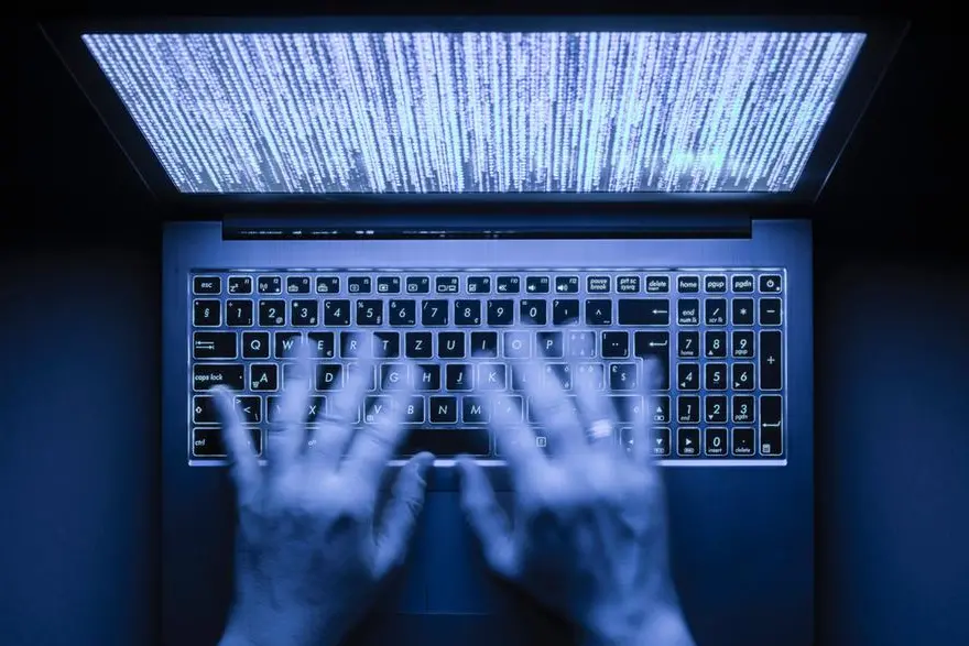 Blurred hands are typing on a laptop computer in the dark with illuminated keyboard and illegible mystic program code visible on the screen. Image used for illustrative purpose. Getty Images , Getty Images