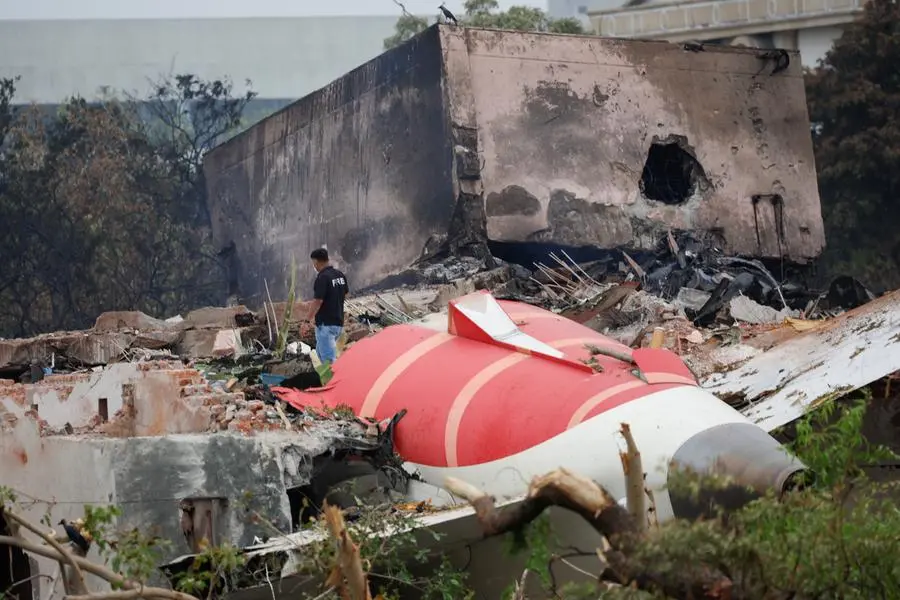A fire offical stands next to the crashed Air India Boeing 787-8 Dreamliner aircraft, in Ahmedabad, India, June 13, 2025. REUTERS/Adnan Abidi. , Reuters