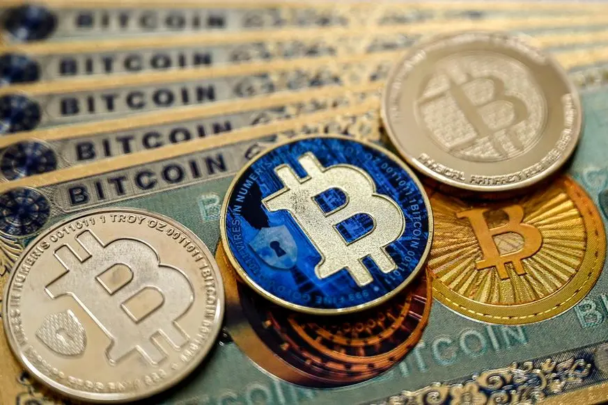 (FILES) This illustration photograph taken on November 22, 2024 in Istanbul shows physical banknotes and coin imitations of the Bitcoin cryptocurrency. - Bitcoin burst past $100,000 for the first time December 5 as traders welcomed Donald Trump\\'s pick to head the US securities commission, while Seoul stocks slipped as South Korea\\'s president faced impeachment after his brief imposition of martial law this week. (Photo by Ozan KOSE / AFP).