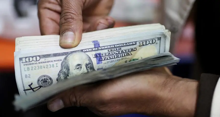 Dollar clings on to gains from US-China trade pact