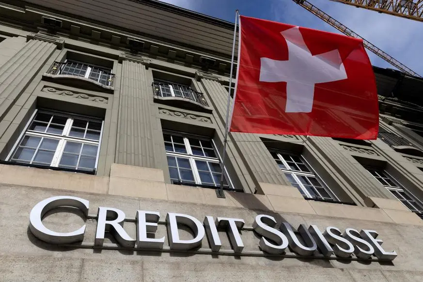 FILE PHOTO: A Swiss flag is pictured above a logo of Swiss bank Credit Suisse in Bern, Switzerland, November 15, 2023. REUTERS/Denis Balibouse. , Reuters