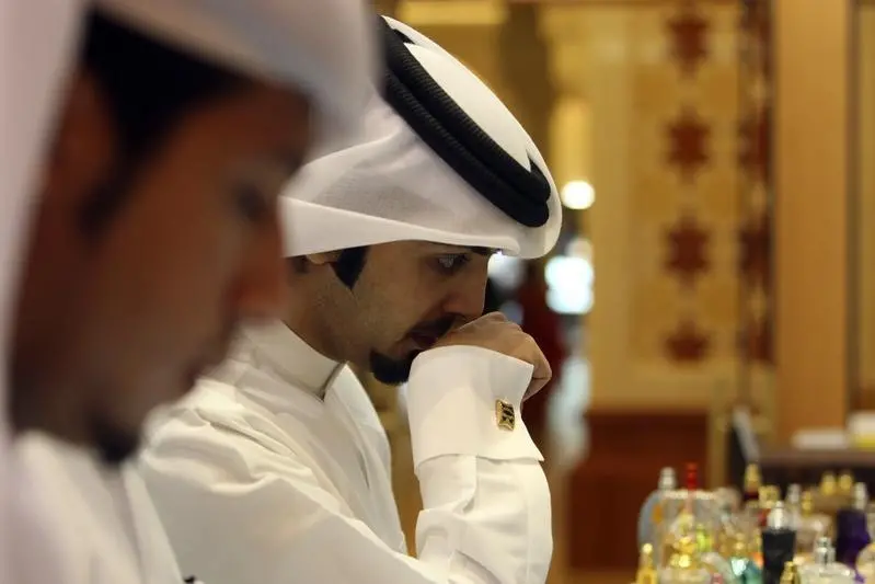 <p>A man tries out perfume samples at an Ajmal fragrance store in Dubai Mall, August 4, 2011</p>\\n