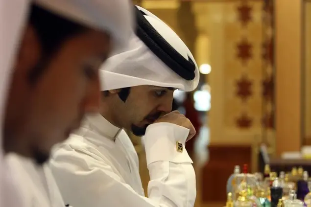 <p>A man tries out perfume samples at an Ajmal fragrance store in Dubai Mall, August 4, 2011</p>\\n