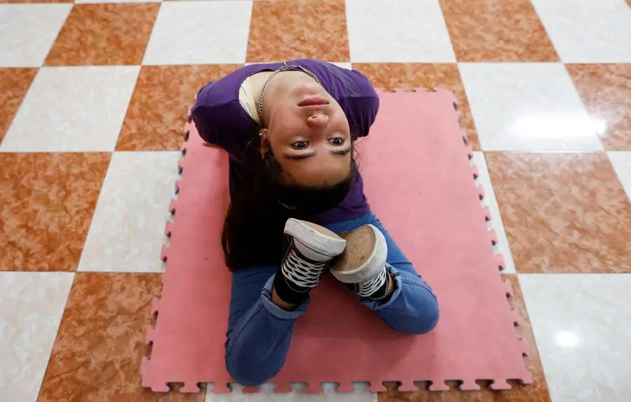 A Palestinian girl Aziza Al-Ghraiz, 12, practices breakdance at a training centre in Nusseirat refugee camp in central Gaza Strip, October 14, 2022. REUTERS/Ibraheem Abu Mustafa