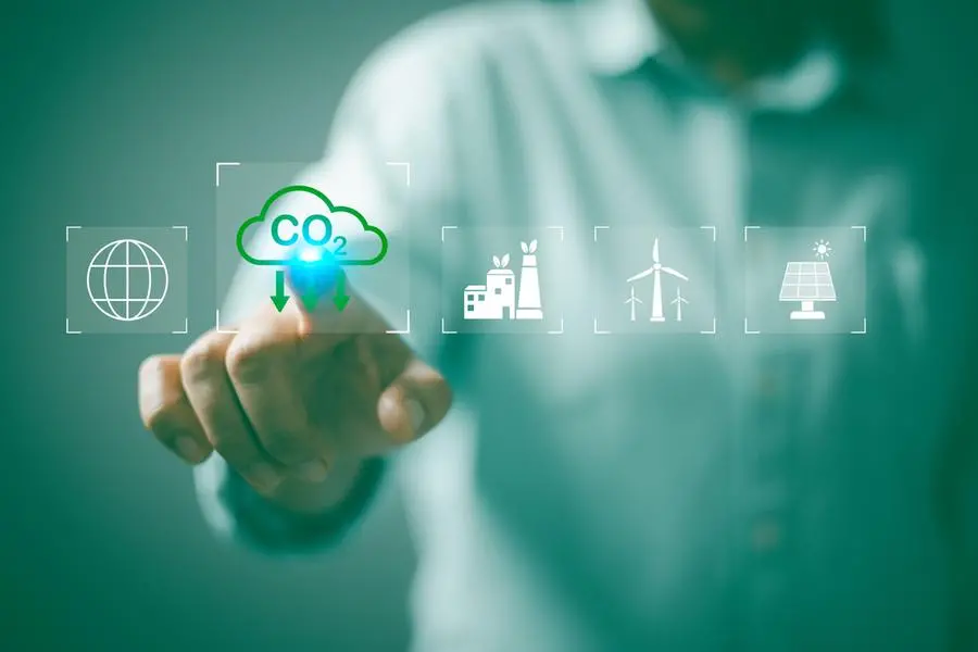 Carbon neutrality net zero. Hand of pollution and effective management with netzero symbols - renewable energy, reduced CO2 emissions, carbon credit to limit global warming from climate change. Image used for illustrative purpose. Getty Images , Getty Images