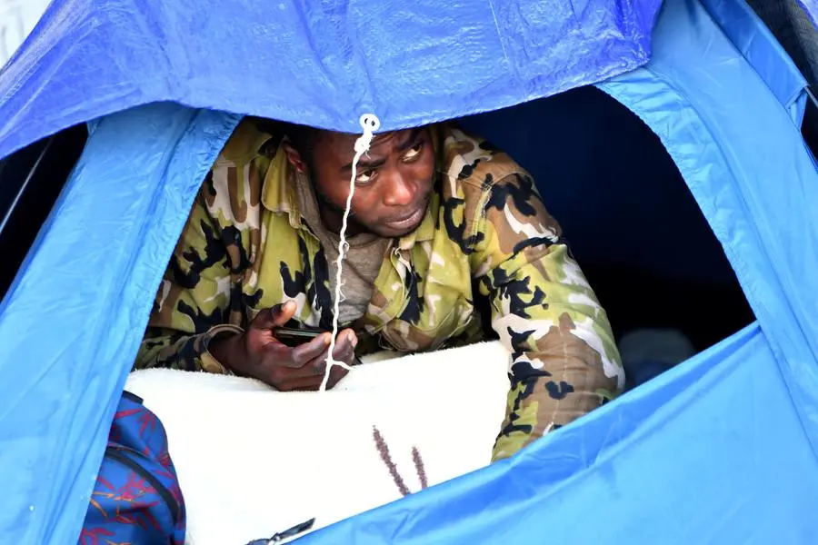 A migrant camps outside the headquarters of the International Organisation for Migration (IOM) in Tunis, on March 7, 2023. (Photo by FETHI BELAID / AFP) Image used for illustrative purpose.