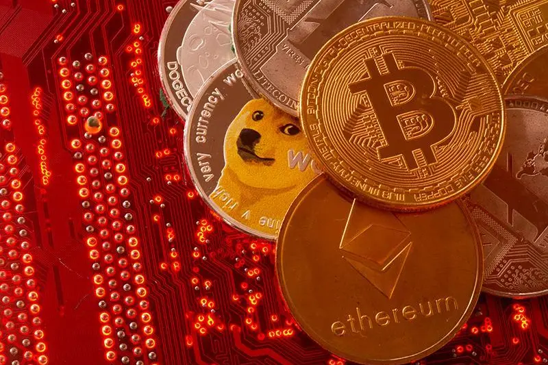 Representations of cryptocurrencies Bitcoin, Ethereum, DogeCoin, Ripple, Litecoin are placed on PC motherboard in this illustration taken, June 29, 2021. Reuters , Reuters Images