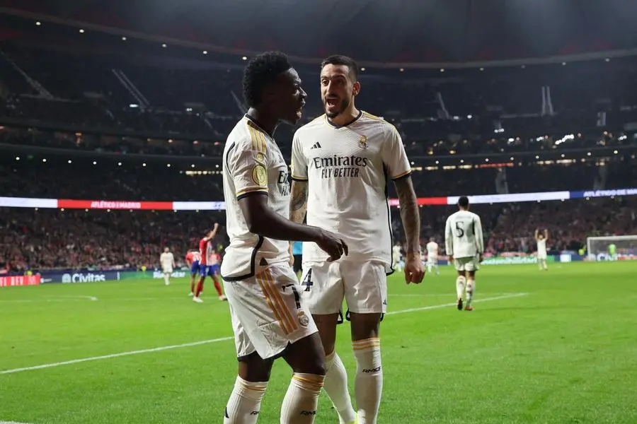 Real Madrid\\'s Spanish forward #14 Joselu (R) celebrates scoring his team\\'s second goal with Real Madrid\\'s Brazilian forward #07 Vinicius Junior during the Spanish Copa del Rey (King\\'s Cup) football match between Club Atletico de Madrid and Real Madrid CF at the Metropolitano stadium in Madrid on January 18, 2024. (Photo by Thomas COEX / AFP) , Agence France-Presse (AFP)/AFP