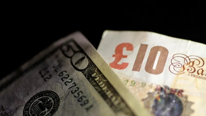 Sterling ticks lower versus dollar in quiet session