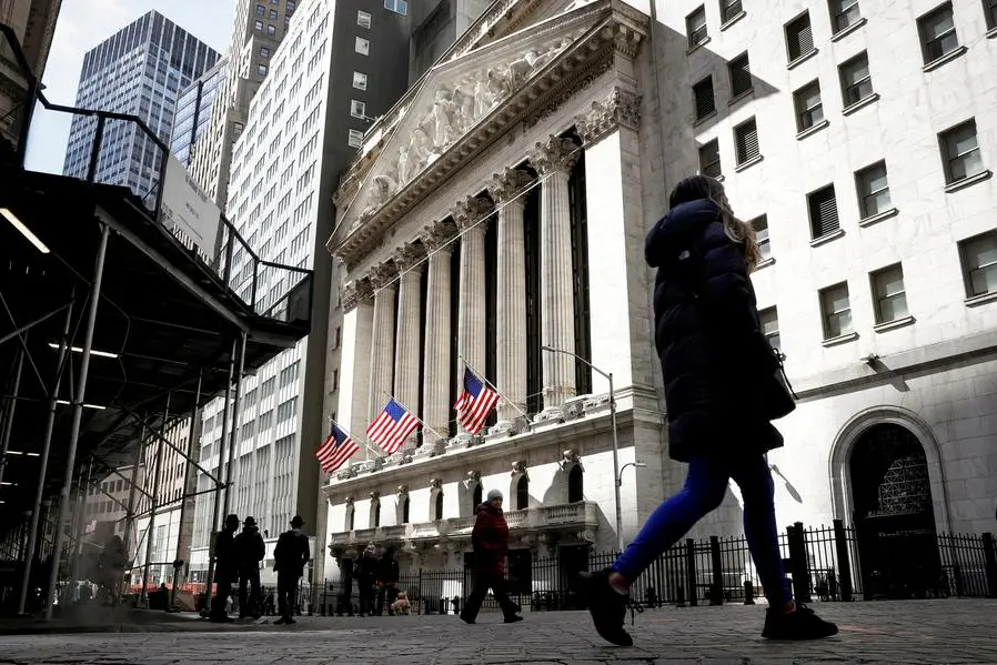 FILE PHOTO: People are seen on Wall Street outside the New York Stock Exchange (NYSE) in New York City, U.S., March 19, 2021. REUTERS/Brendan McDermid//File Photo , Reuters/REUTERS