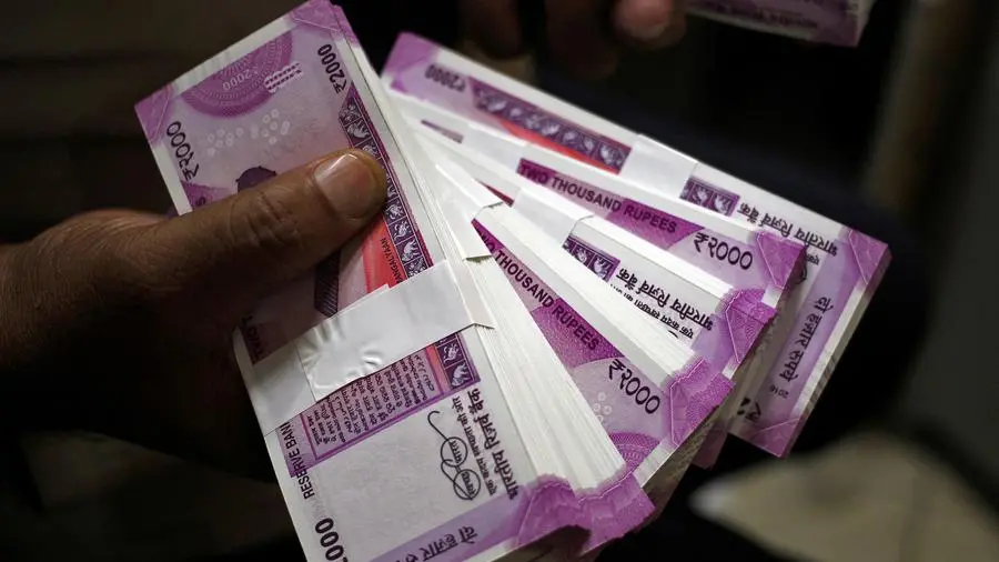 Indian rupee ends moderately higher as oil firms' dollar bids curb upside