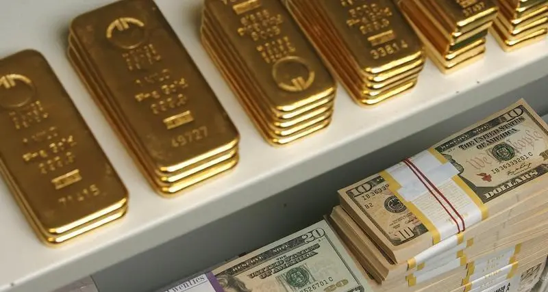 Gold slips as firmer dollar offsets bets on Fed pause