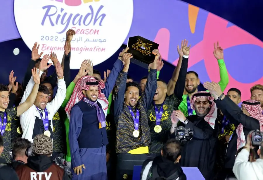 Soccer Football - Friendly - Saudi Pro League XI v Paris St Germain - King Fahd International Stadium, Riyadh, Saudia Arabia - January 19, 2023 Paris St Germain's Marquinhos celebrates winning the match with a trophy and teammates REUTERS/Ahmed Yosri