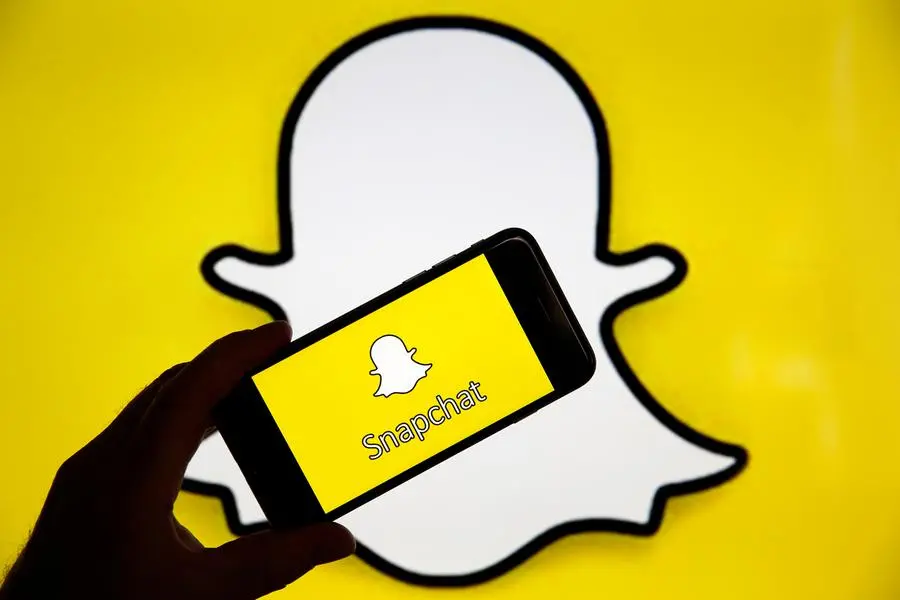 In this photo iIllustration, the Snapchat social media logo is displayed on the screen of an iPhone in front of a computer screen showing a Snapchat logo on April 05, 2019 in Paris, France. (Photo by Chesnot/Getty Images) , Getty Images