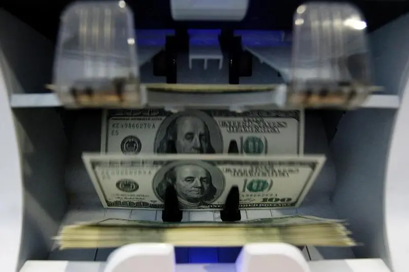 Money counter counts 100 U.S. dollar banknotes in a bank in Bern. Pascal Lauener, Reuters