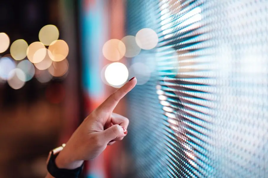 Female hand touching illuminated digital display in the dark. Getty Images Image used for illustrative purpose , Getty Images