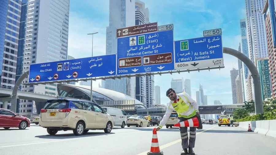 Standing by traffic lights, Dubai Police officers skip every iftar with family to serve drivers
