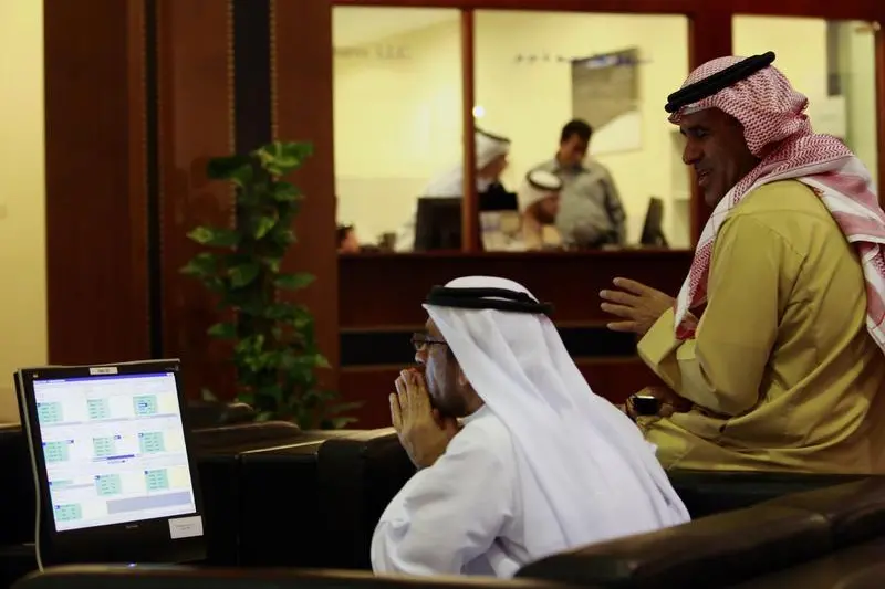 Investors look at stock exchange information at the Dubai Financial Market December 14, 2009. STR New, Reuters , Reuters Images