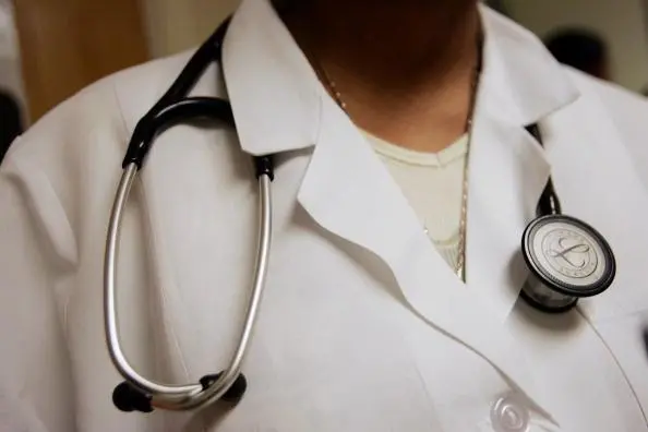 DORCHESTER - APRIL 05: Dominique Entzminger, a physician assistant of family medicine, wears a stethoscope during an examination at the Codman Square Health Center April 5, 2006 in Dorchester, Massachusetts. (Photo by Joe Raedle/Getty Images) Image used for illustrative purpose. , Getty Images