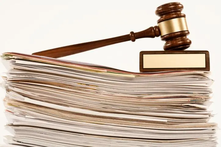 gavel on stack of documents on white background , Getty Images/Getty Images