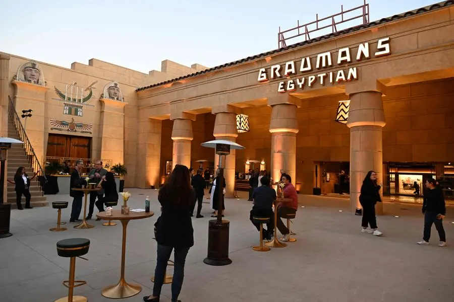 Visitors attend the press preview for the reopening of the Egyptian Theatre, in Hollywood, California on November 6, 2023. The Egyptian Theatre, which hosted Hollywood\\'s first-ever red carpet premiere in its faux hieroglyph-adorned courtyard more than a century ago, reopens this week under the new ownership of Netflix. For Netflix co-CEO Ted Sarandos, the chance to save a crumbling Tinseltown institution -- and showcase his company\\'s rapid ascent from tech disruptor to a key player at the very heart of the entertainment industry -- was a no-brainer. (Photo by Robyn Beck / AFP) , Agence France-Presse (AFP)/AFP