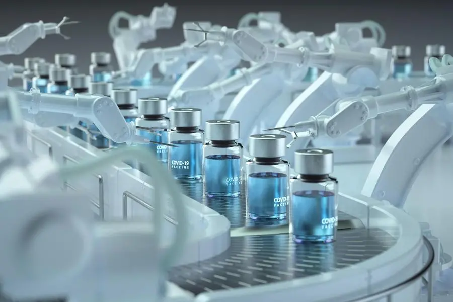 Digital generated image of COVID-19 vaccine bottles standing on robotic production line. Image used for illustrative purpose. , Getty Images