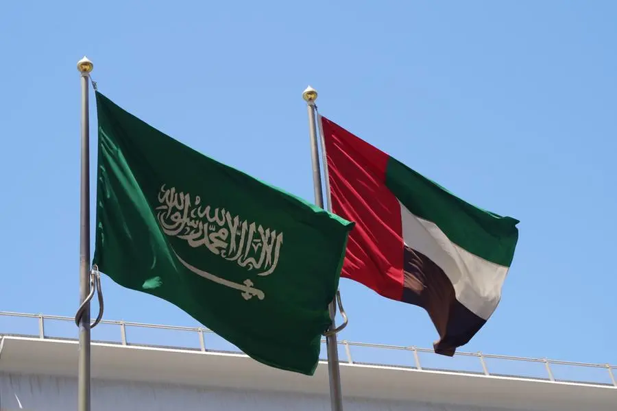 Saudi Arabia and United Arab Emirates national flags waving on flagpoles in the sky. Most important nations in the Arabic Gulf. Image Courtesy: Getty Images , Getty Images/iStockphoto