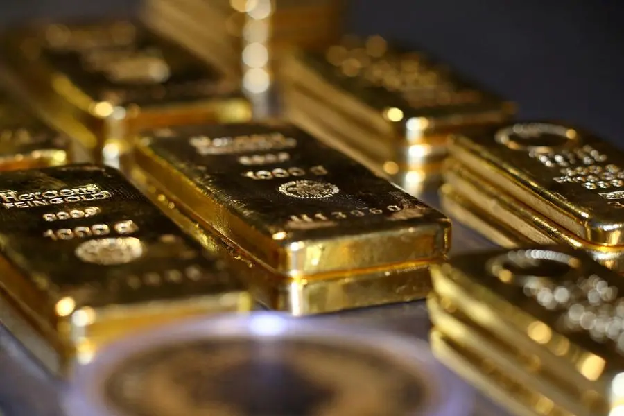 Gold bars and coins are stacked in the safe deposit boxes room of the Pro Aurum gold house in Munich, Germany, August 14, 2019. REUTERS/Michael Dalder. Image used for illustrative purpose only.