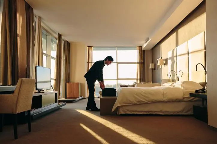 Image used for illustrative purpose. Businessman packing luggage in hotel bedroom. Getty Images , Getty Images